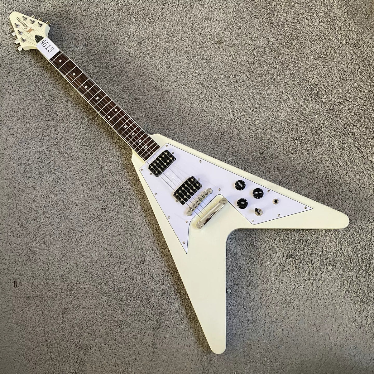 Flying V electric guitar with swallowtail design, 22 frets, Italian Okoume body, uniquely shaped stand, manufactured in Italy.