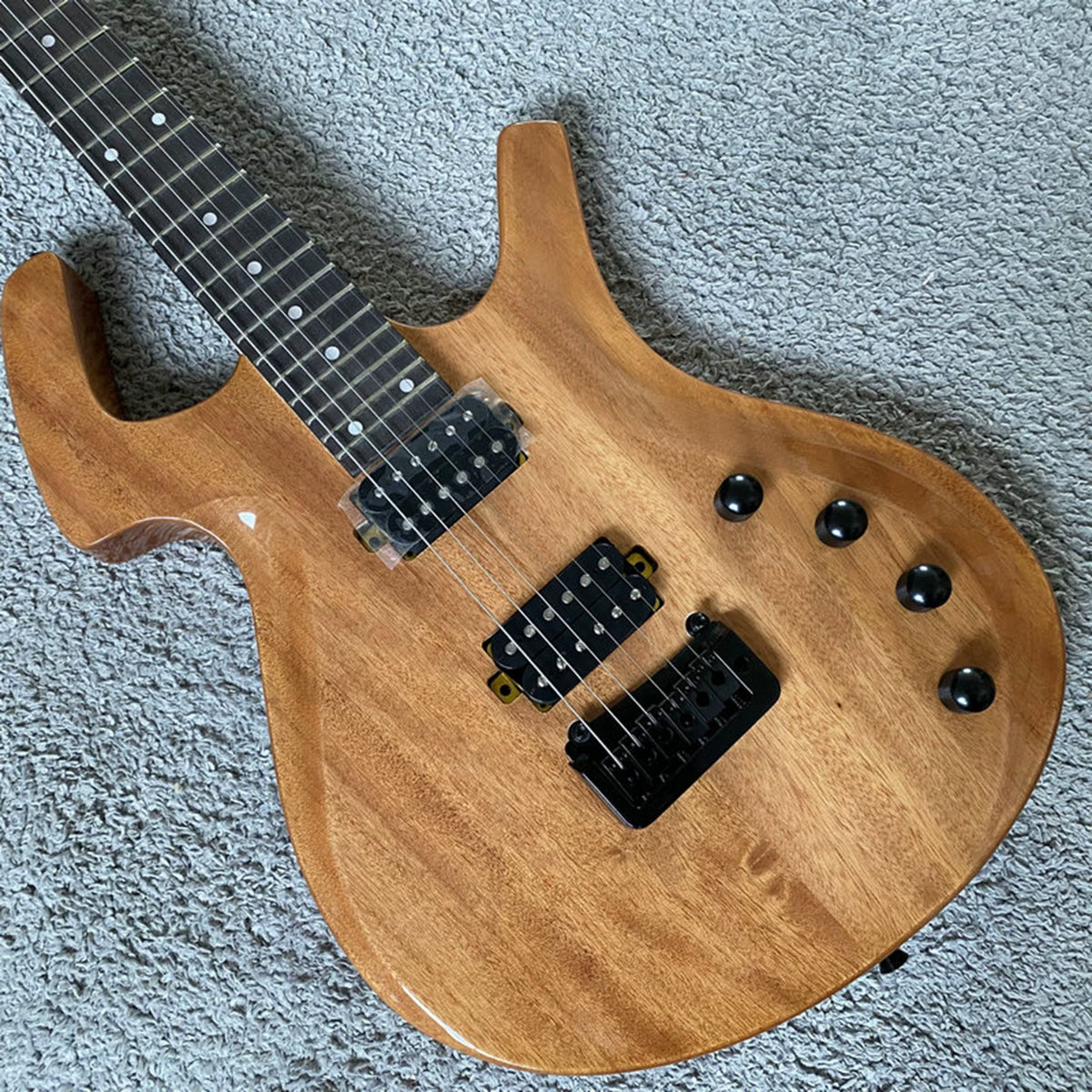 Solid mahogany body, 24 frets, rosewood double-tremolo electric guitar, Parker style, brand-name, with polished label, for export.