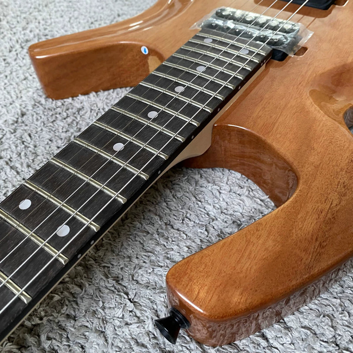 Solid mahogany body, 24 frets, rosewood double-tremolo electric guitar, Parker style, brand-name, with polished label, for export.