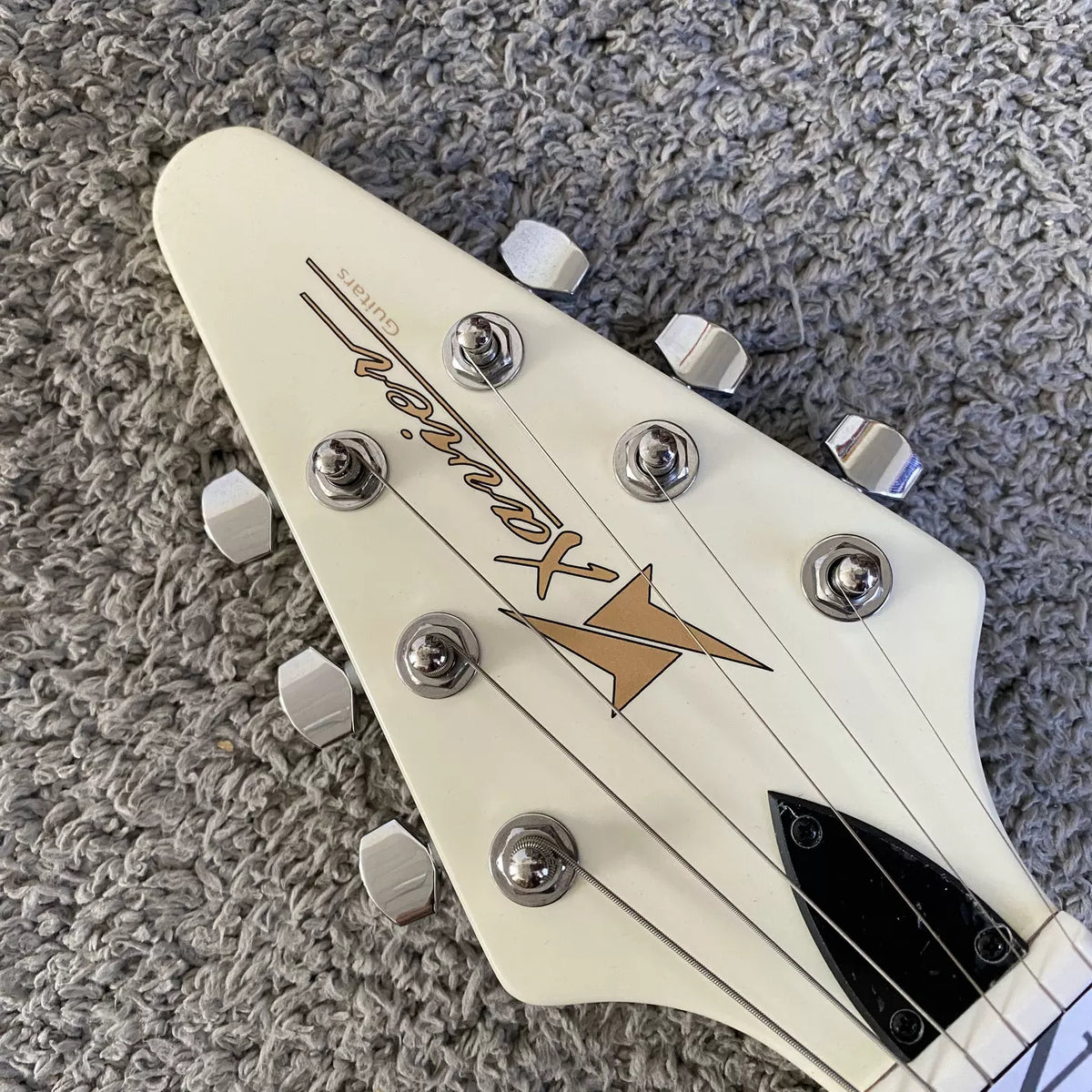 Flying V electric guitar with swallowtail design, 22 frets, Italian Okoume body, uniquely shaped stand, manufactured in Italy.